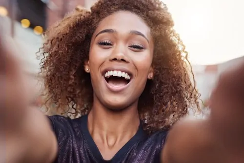 woman taking smiling selfie