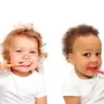 2 toddlers brushing their teeth